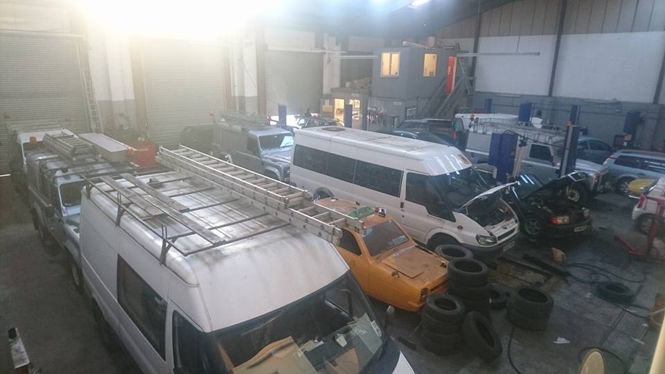 Inside the Station Motors workshop, with vans and cars in for work