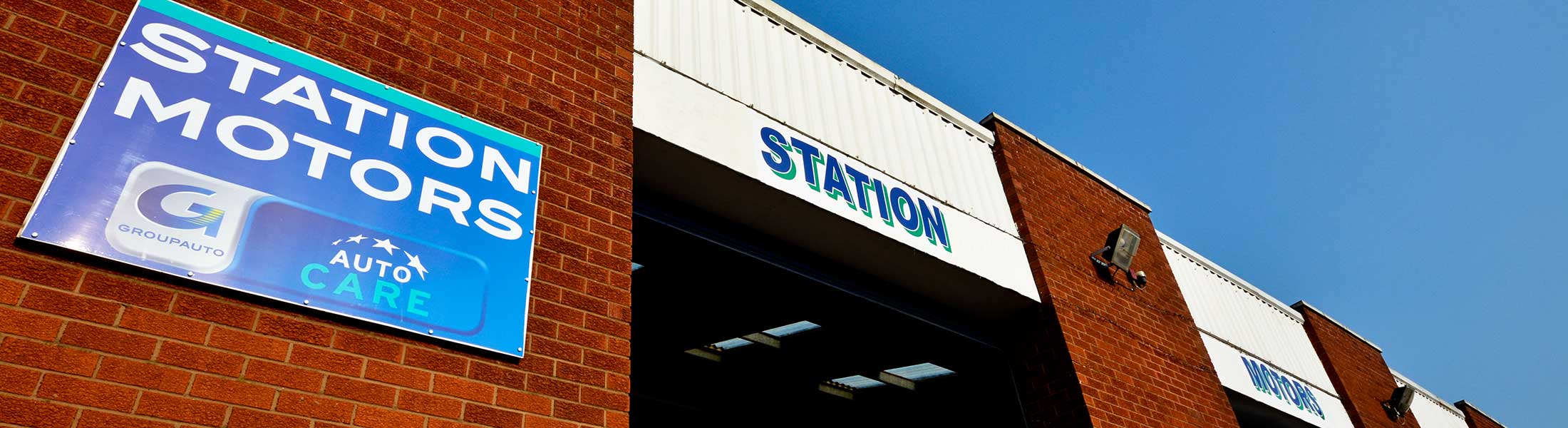 The Station Motors sign and workshop frontage at Station Yard, Leominster